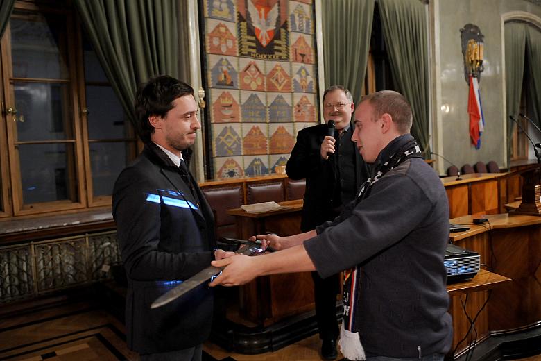 Miecz - symbol wygranej w sportowych zmaganiach - przedstawiciele "Wisły" odebrali z rąk kibiców "Cracovii",